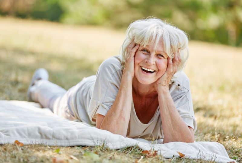 An old lady smiling after all on 4 dental implant procedure