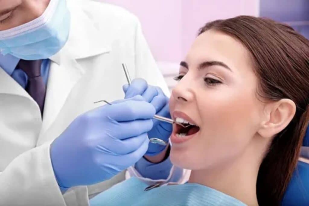 Periodontist examining a patient with a loose tooth in Houston, TX.