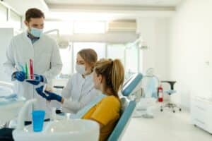 Dental professionals discussing treatment options with patient in Houston periodontal office.